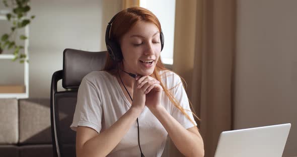 Head Shot Redhead Teen Girl Sits in Front of Laptop, Wears Head Microphone, Speaks with Family alt