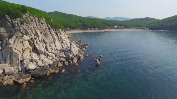 Drone View of the Beautiful Sea Rocky Coast with Clear Blue Water alt