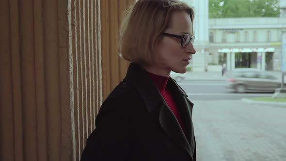 Restless Sad Woman Near Wall at City Street alt