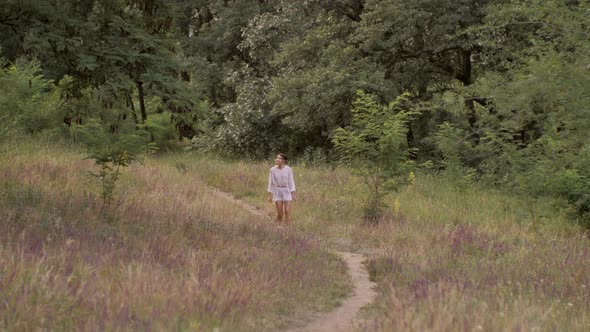 Beautiful Woman Walking Outdoors on Nature alt