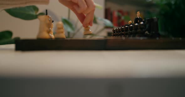 Close Up To People Hands Playing Chess Game at Home
