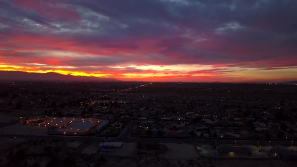 Sedona city aerial shoting forward. Fantastic desert city drone view at sunset. alt