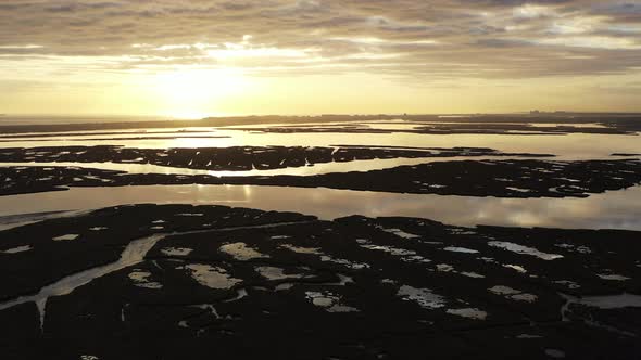 An aerial shot over Baldwin Bay near Freeport, NY at sunset. The camera truck left & pan right while alt