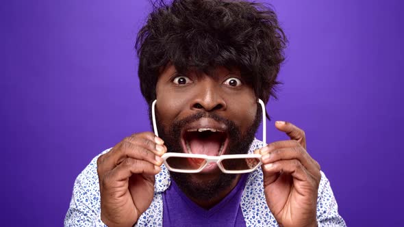 Shocked Amazed Young Bearded Black African American Man Purple Background alt