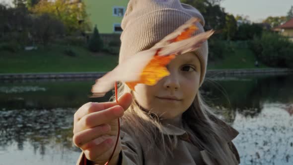 Portrait Girl and Autumn Maple Leaf