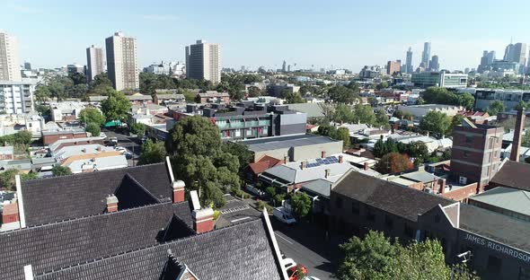Drone ascend and reveal of Melbourne showing old original areas, and commotion flats through to city alt