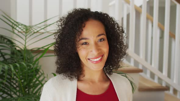 Portrait of african american woman looking at camera and smiling alt