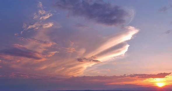 A Dramatic Orange Sunset Through the Clouds alt