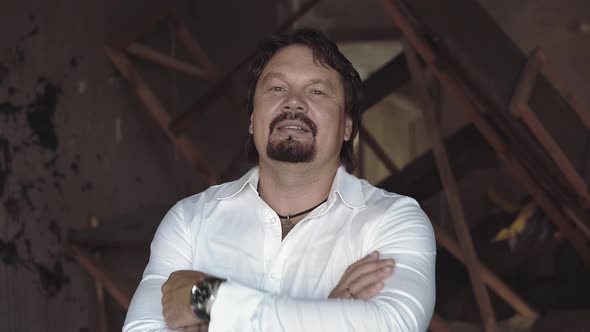 Portrait of a Brutal Young Man with a Beard That Laughs Closeup alt