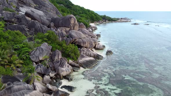 a beach with big rocks and a huge rock