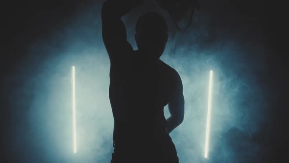 Silhouette of a Dancing Sexy Man in Smoke