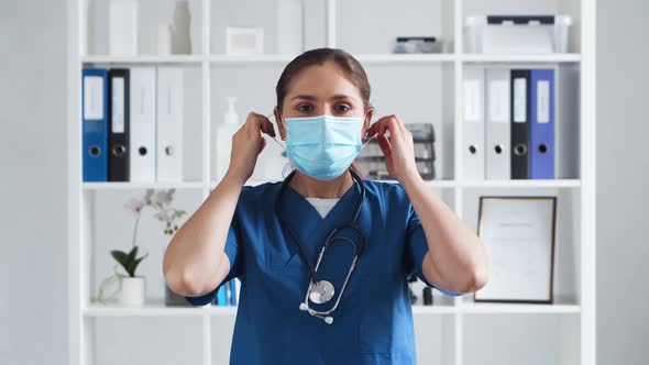 Professional medical doctor working in hospital office. Young and attractive female physician. alt