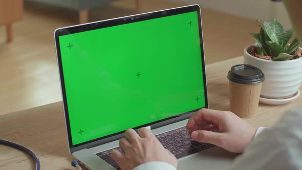 Close Up Male Doctor Typing On Laptop Computer With Green Screen Display At Home Office alt