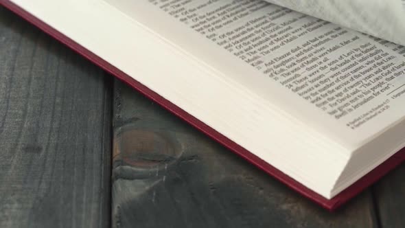 Close Up of Leafing Book Pages on Gray Wooden Table alt