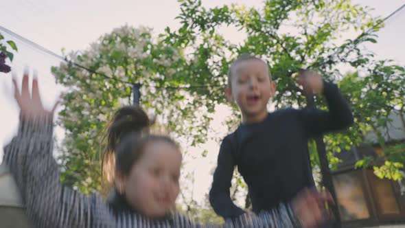Children Jump on the Trampoline