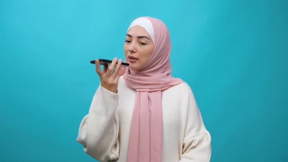 Muslim Woman in Hijab Leaves a Voice Message on the Mobile Phone