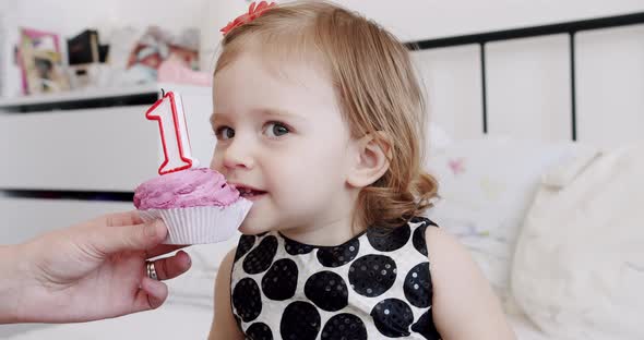 A Birthday Party for a Cute and Happy 1 Year Old Girl and Eating a Little Cake alt