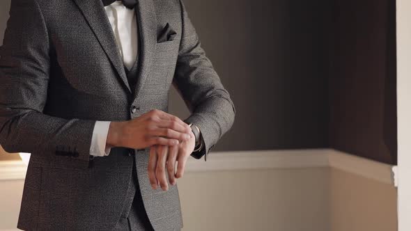 Handsome Stylish Groom Man Looking on Wrist Watch at Home Gets Ready Before Date Meeting with Bride alt