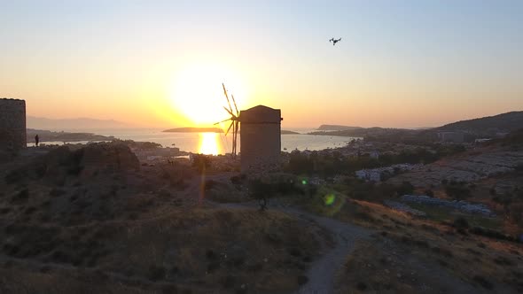 Filming the Old Traditional Historic Stone Windmill by the Sea With Professional Drone From the Air