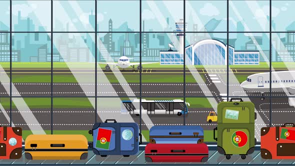 Baggage with Portuguese Flag Stickers on Carousel in Airport alt