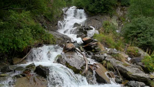 Waterfall in mountains in national park of Dombay