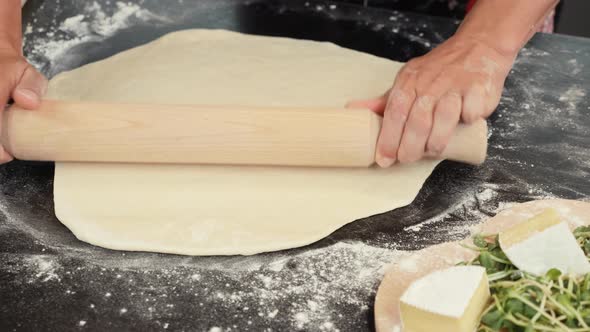 Process of making traditional italian pizza. Female hands working with dough for pizza alt