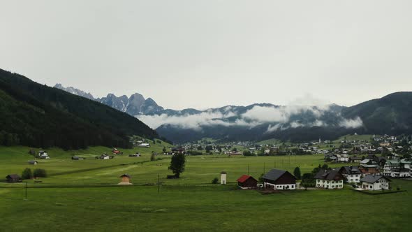 Panoramic View of a Picturesque Mountain Valley with a Village in a Lowland alt