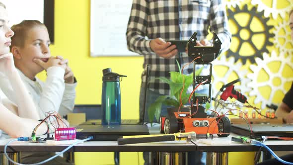 Male Teacher and Students in VR Glasses at Lesson