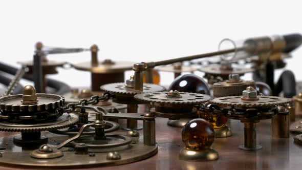 A Complex Mechanism with Many Rotating Gears, Chain, Piston, Cogs. Very Similar To a Clock Mechanism alt