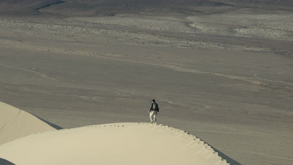 Hiker on the Eureka Dunes - Death Valley National Park alt