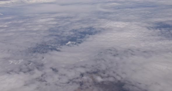 Sky View on the Plane of Airplane Flying Above the Clouds in the Sky alt