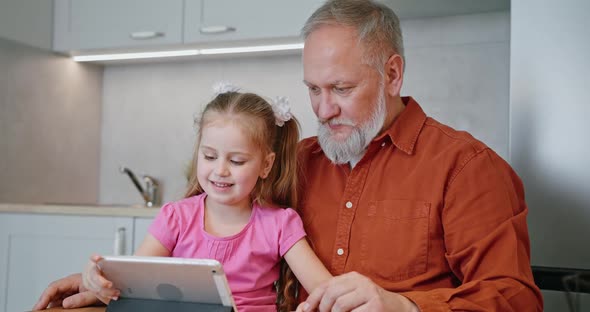 Grandpa and Cute Small Kid Daughter Bloggers Recording Lifestyle Vlog on Digital Tablet Talking