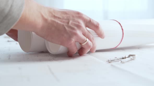 Close-up of an architect's hands. Professional real estate designer alt