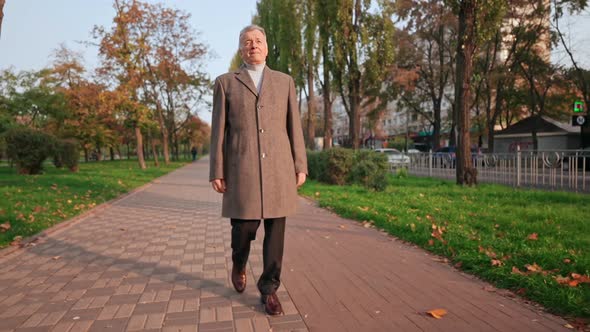 Mature Stroll in Park in Fall