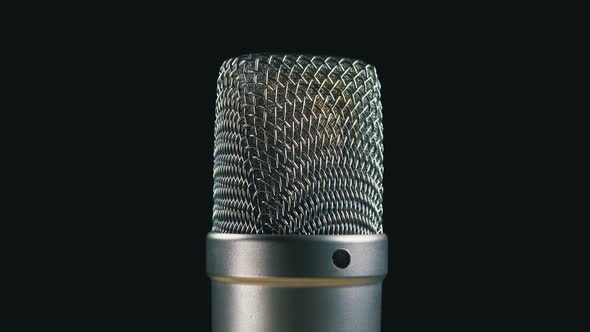 Studio Condenser Microphone Rotates on a Black Background alt
