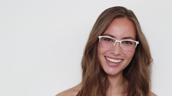 Girl Wearing Eyeglasses Walking In, Poses with a Smile and then Walking Out alt