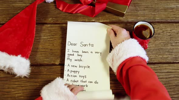 Santa claus reading a letter alt