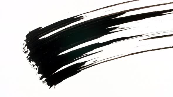 Macro Shot and Slow Motion of a Black Mascara Isolated on White Background alt