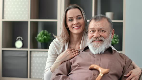 Happy Daughter Granddaughter and Senior 80s Disabled Father Grandfather Hugging Posing Together alt