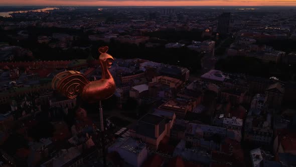 Riga's Golden Weather Cock or Rooster in Beautiful Old Town During Amazing Scenic Sunrise Aerial alt