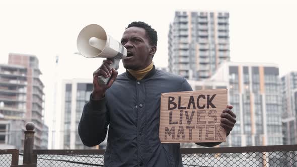 African American Man Holds Megaphone and Shouts alt