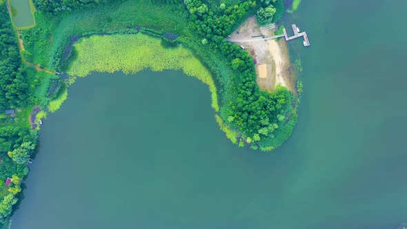 Epic Top Down Aerial View of Big Lake With Clear Blue Water. Reflection of Sky in Clear Lake in Even alt