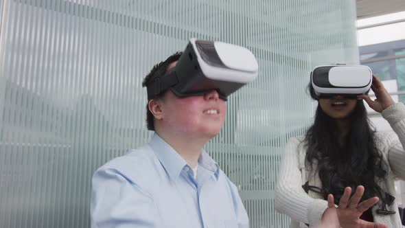 Two young people wearing VR goggles