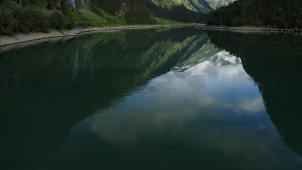 Aerial Reveal Faatage Starting with Lake and Ending with Mountain alt