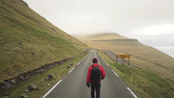 Hiker Walking On Mountain Road On Vidareidi alt