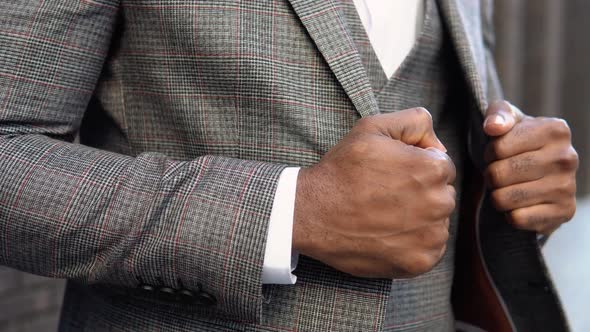Closeup of a Elegant African Businessman in Brown Jacket and Coat Near Office Center alt