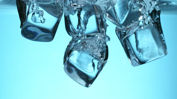 Super Slow Motion Shot of Clear Ice Cubes Falling Into Water at 1000Fps alt