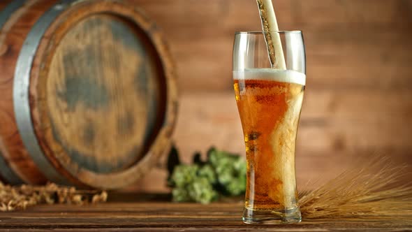 Super Slow Motion Shot of Pouring Fresh Beer Into Glass on Wooden Table at 1000Fps. alt