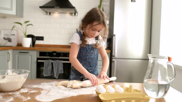 Cute Toddler Girl Cooking Kneads the Dough