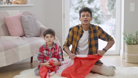 Middle Eastern Hockey Fans Rejoicing Victory Watching Match on TV at Home alt